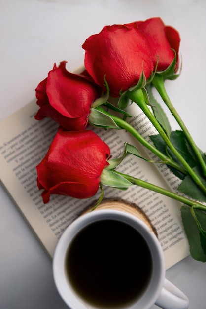 Female hand with cup of coffee, rose ...